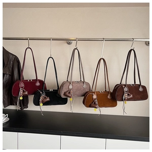 Detailed display of vintage suede Boston bags in five colors with decorative charms