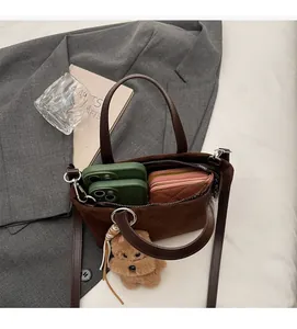 Detail shot of brown suede bucket bag interior showing capacity for phones and wallet