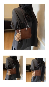 Brown suede tote bag with silver buckles and a cute teddy bear charm detail