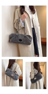 Detail of gray denim tote bag with vintage frayed edges and metal label plate accents