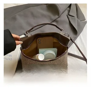 Detail showing inner capacity for phone and cosmetics of the color-block handbag