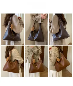 Multiple views of a large matte leather tote bag with a plush bear charm on a model