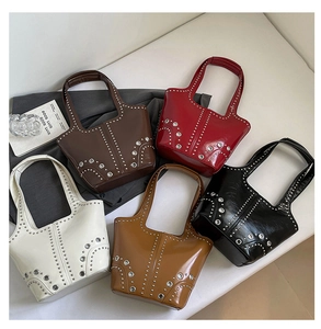 Detailed overhead view of retro rivet tote bags in five colors with silver metallic studs