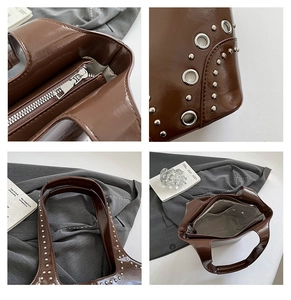 Dettaglio della borsa tote marrone vintage con rivetti e tasca interna con cerniera