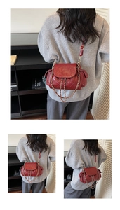Macro shot of red quilted faux leather texture with elegant golden chain strap detail