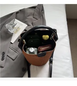 Top view of brown suede bucket bag showing large interior capacity with daily essentials