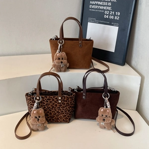 Three autumn-style tote bags in leopard print and solid brown with plush puppy pendants