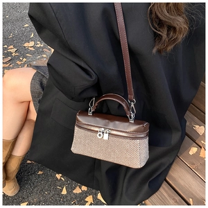 Detail of contrast stitching and herringbone fabric texture on this stylish handbag