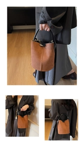 Macro detail of brown matte suede bucket bag showing leather straps and buckle