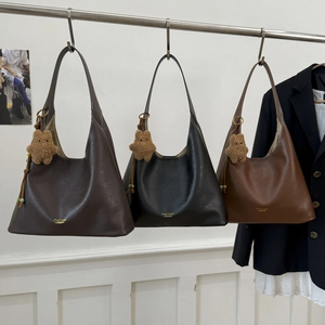 Close-up of hobo shoulder bags in brown and black leather with golden brand logo