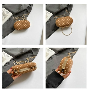 Polka dot suede evening clutch with golden metal handle and chain strap detail