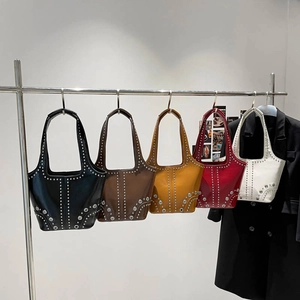 Studded bucket bag in multiple colors with metallic rivets and bohemian style