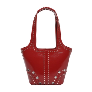 Vintage red patent leather tote bag with silver rivets and punk style metallic details