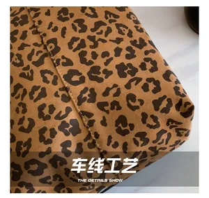 Close-up of precise stitching and leopard print texture on a large tote bag