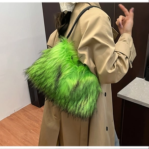 Detail of fuzzy lime green faux fur shoulder bag with long hair texture and black strap