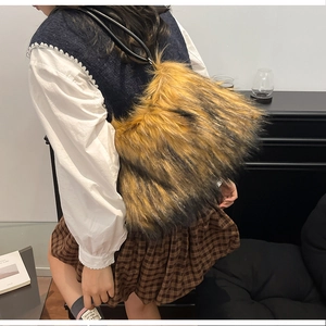 Chic long faux fur shoulder bag in mixed brown and black with leather strap on model
