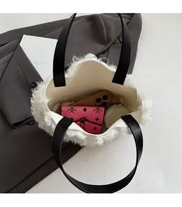 Spacious interior of white faux fur tote bag showing room for phone and wallet