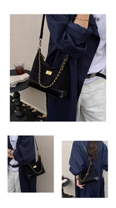 Detail of vintage quilted leather and suede hobo bag with gold chain and twist lock