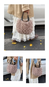Close-up of pink plush bucket bag with rose swirl texture and black handles