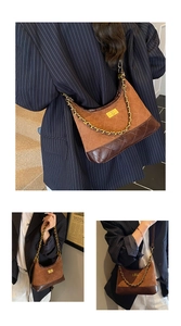 Detail of vintage quilted leather messenger bag with gold turn-lock and chain strap