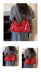 Detail of glossy red patent leather shoulder bag showing the side drawstring design