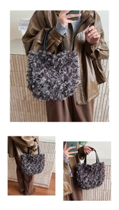 Detailed texture of charcoal grey plush bucket bag with black leather handle