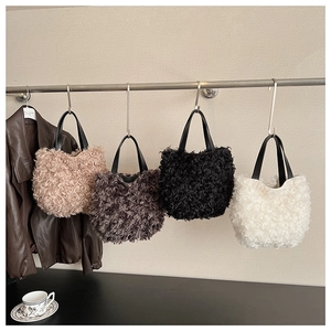 Hanging display showing four colors of curly faux fur tote bags with PU handles