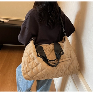 Khaki quilted travel bag featuring large capacity diamond stitching and black nylon strap