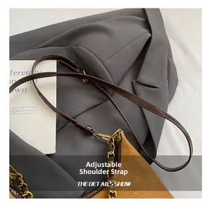 Detail of adjustable leather strap with gold chain on brown quilted crossbody bag