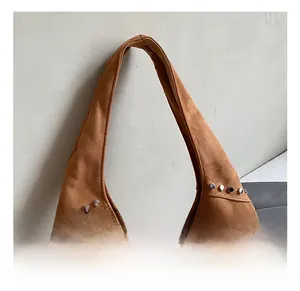Detail showing the brown suede hobo bag with silver metallic rivet stud decorations