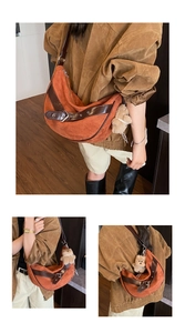 Detail of caramel suede crescent bag featuring adjustable dark brown leather strap and bear charm