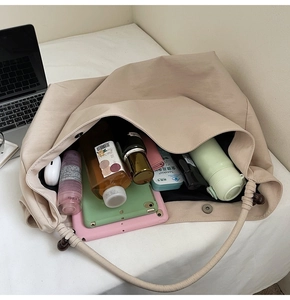 Spacious beige tote bag interior showing large capacity for laptop and essentials