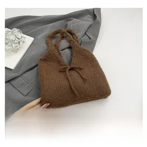 Detailed knit texture of a brown bow shoulder bag with thick woven wool craftsmanship