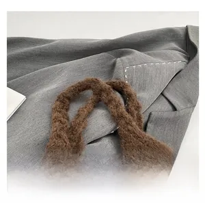 Close-up of comfortable knit handle detail on brown plush autumn winter tote bag