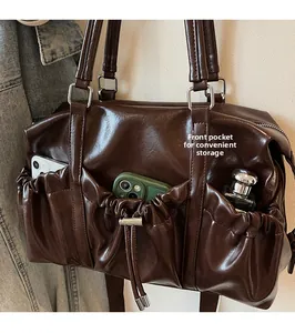 Detail view of the front drawstring pocket showing storage capacity for phone and perfume