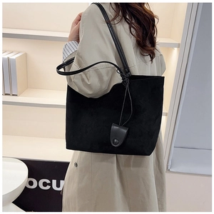 Detail of black matte suede tote bag with slim shoulder straps for daily commuting