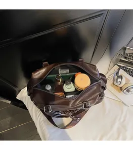 Spacious interior of dark brown glossy leather tote bag with various daily essentials