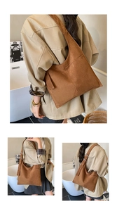 Macro view of dark brown faux suede tote bag with smooth texture and vintage design