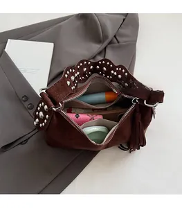 Internal view of brown suede crossbody bag showing ample space for daily essentials