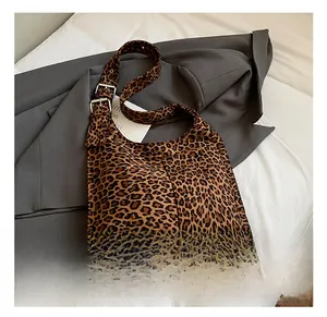 Detailed close-up of leopard print shoulder bag with adjustable strap and metal hardware