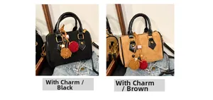 Detail of diamond quilted suede boston bag with glossy handles and plush charm accessory