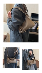 Detail of suede shoulder bag featuring long side tassels and silver metal rivets on strap