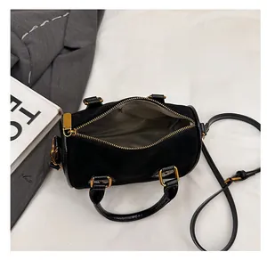 Top view of open black frosted suede Boston bag showing minimalist interior storage space