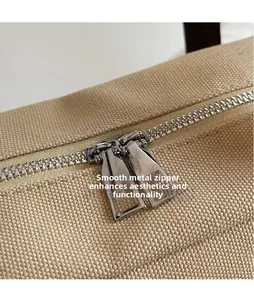 Macro shot of durable canvas tote with smooth dual silver metal zippers and dense teeth
