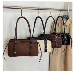 Detailed close-up showing four vintage leopard and suede baguette bags hanging on hooks
