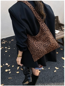 Detail of large leopard print hobo bag showing texture and slouchy fit on model