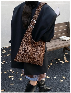Detail of leopard print hobo bag showing adjustable strap buckle and canvas texture