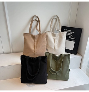 Corduroy tote bags in khaki, beige, black, and green arranged on white marble steps