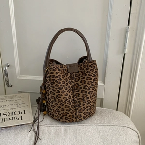 Detail of leopard print suede bucket bag with wooden beads and leather tassel