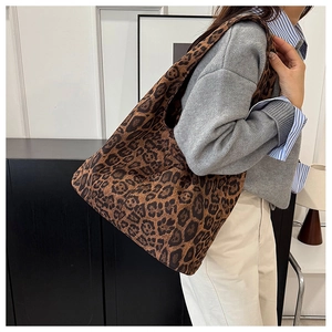 Detail of leopard print canvas tote bag on model in a modern home setting